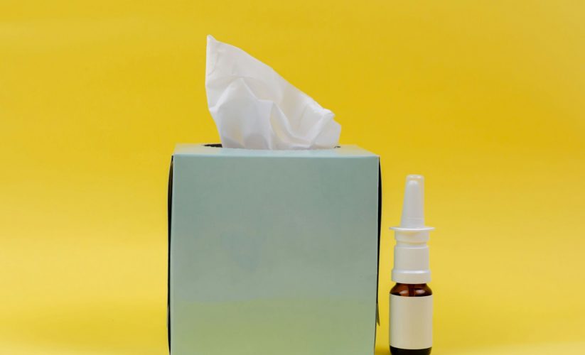 white and brown bottle beside white tissue box