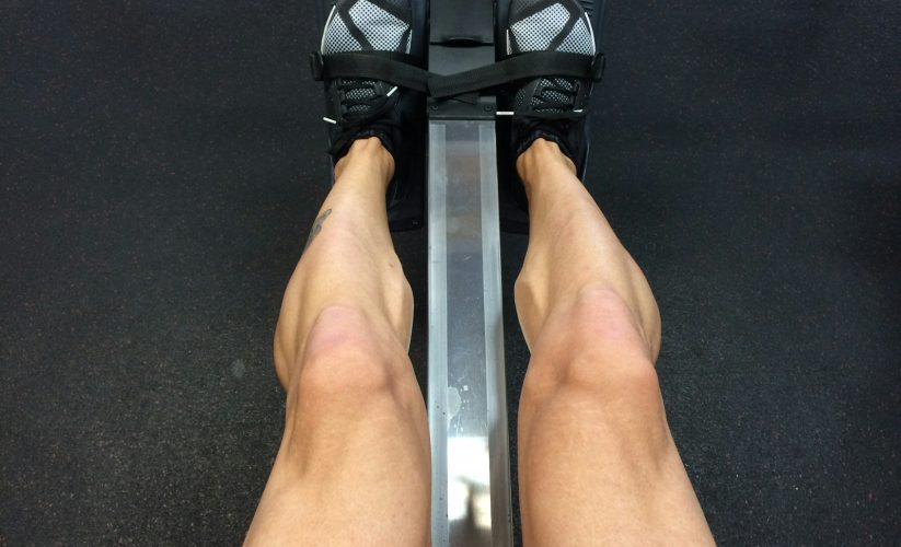 person sitting on rowing machine